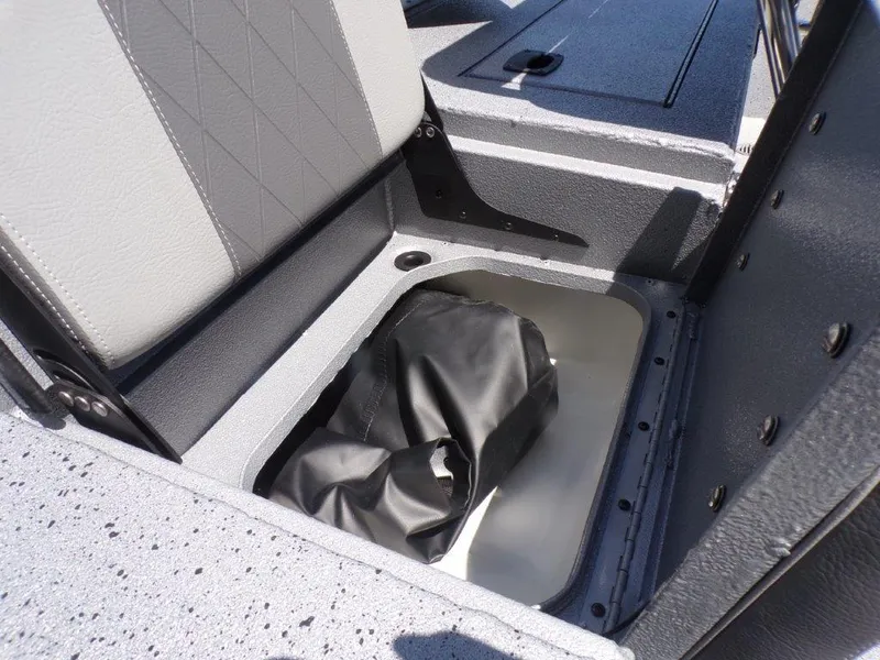Slide: The Image of 2026 Xpress SW20BAY boat storage compartment with black bag inside. - 19