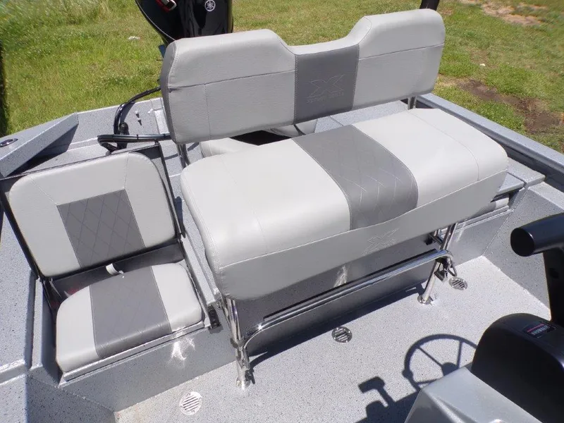Slide: The Image of 2026 Xpress SW20BAY boat seats, gray upholstery, outdoor setting. - 20