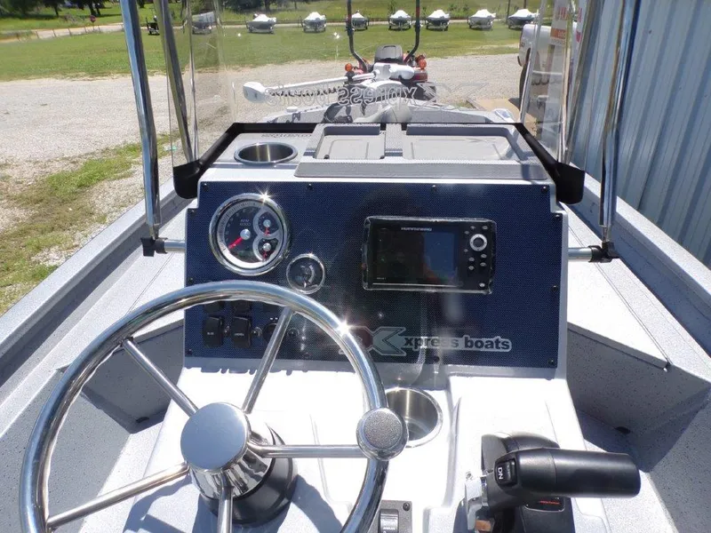 Slide: The Image of 2026 Xpress SW20BAY boat dashboard with steering wheel, gauges, and control panel. - 4