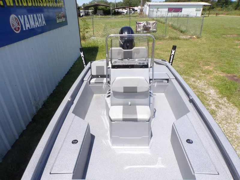 Slide: The Image of 2026 Xpress SW20BAY boat with center console, parked outdoors near Yamaha sign. - 8