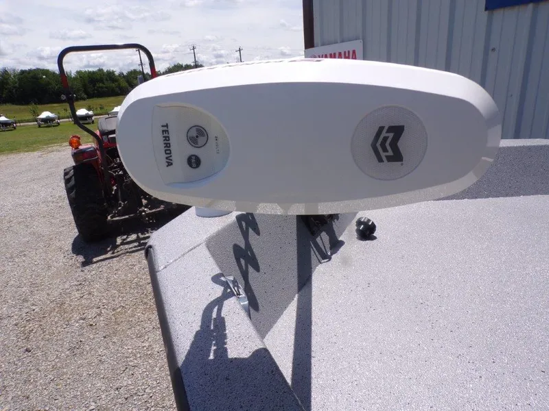 Slide: The Image of 2026 Xpress SW20BAY boat with Minn Kota Terrova trolling motor, parked near a tractor. - 9