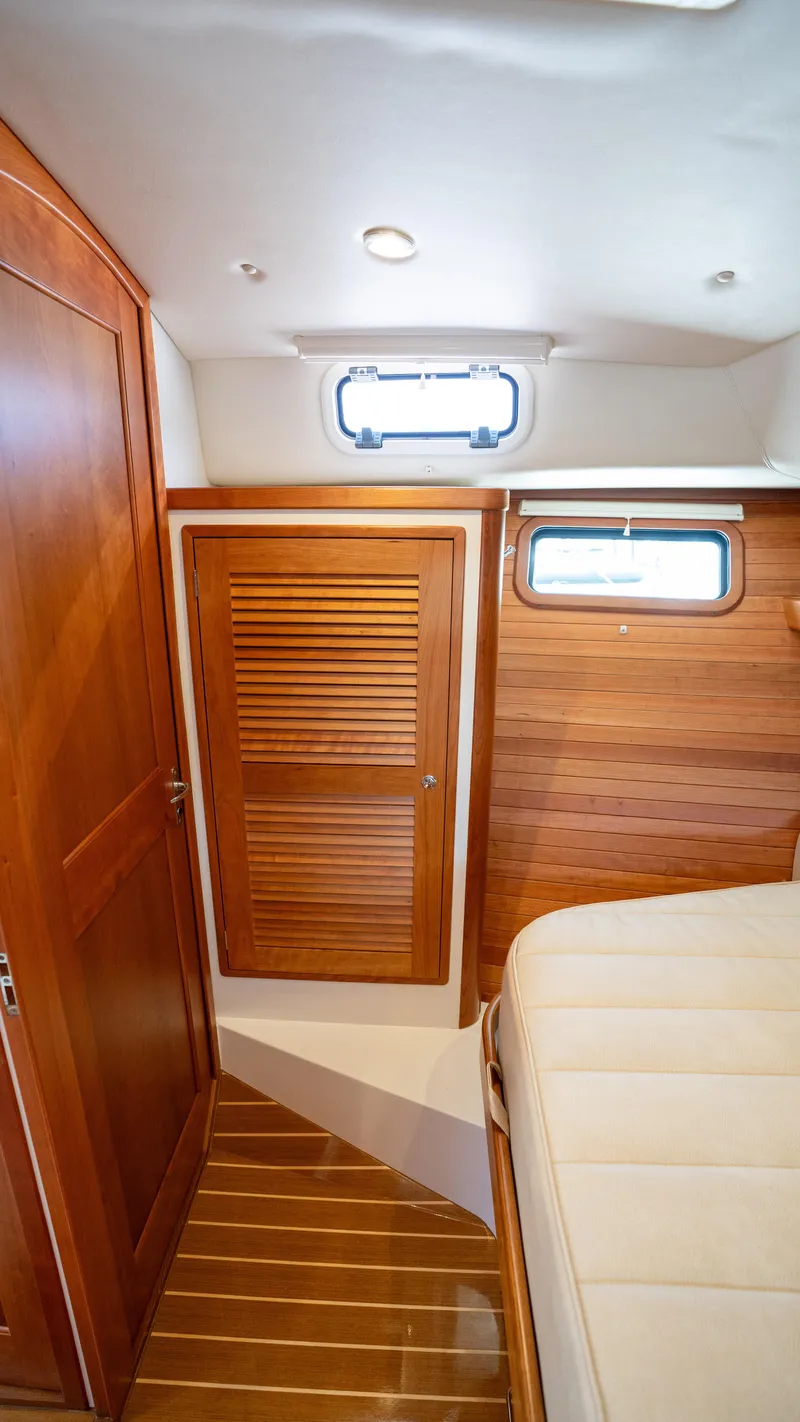 Slide: The Image of 2017 MJM 40z Downeast cabin interior with wooden finishes and a small window. - 12