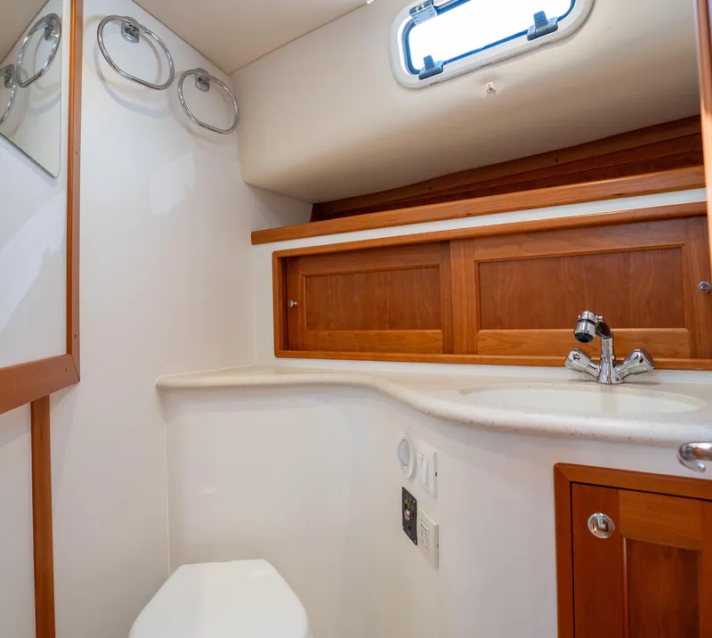 Slide: The Image of 2017 MJM 40z Downeast yacht bathroom with wooden cabinets and modern fixtures. - 13