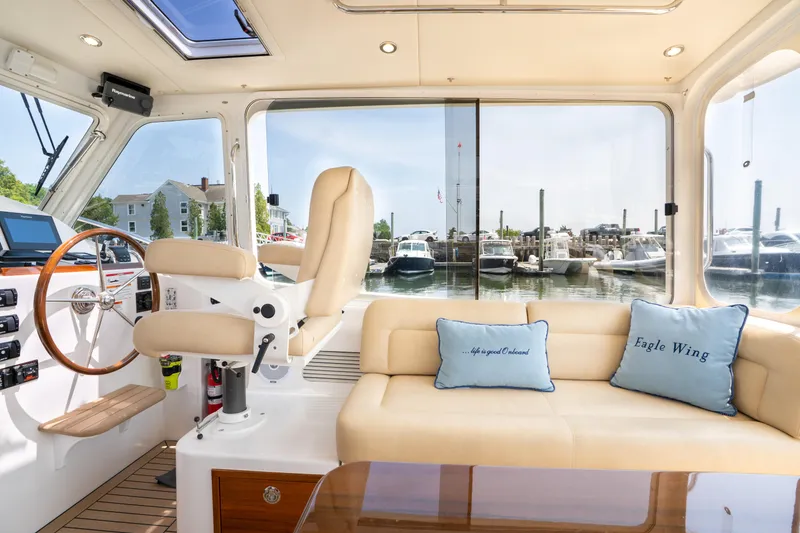 Slide: The Image of Interior of 2017 MJM 40z Downeast yacht with helm, seating, and marina view. - 3
