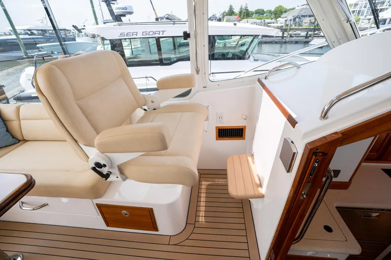 Slide: The Image of Interior of 2017 MJM 40z Downeast yacht with beige seating and wooden accents. - 5