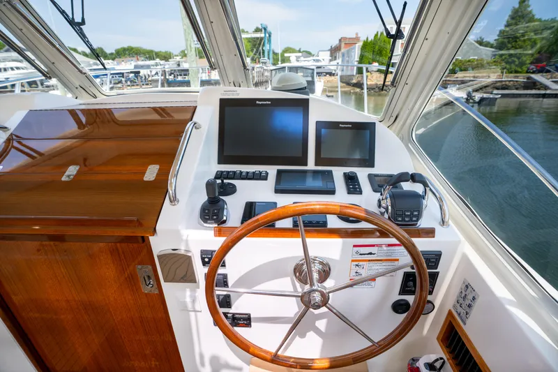 Slide: The Image of Helm of 2017 MJM 40z Downeast boat with navigation screens and wooden steering wheel. - 7