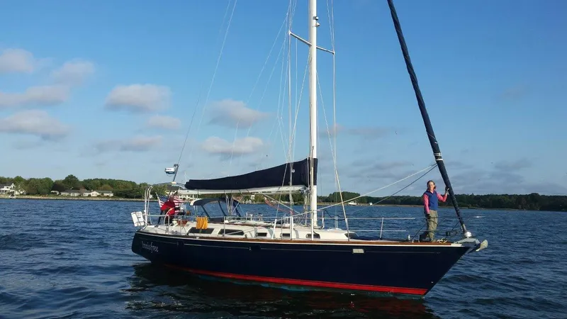 The Image of 1994 Sabre SABRE 425 sailboat on calm water under clear blue sky. - 0