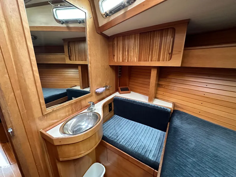 Slide: The Image of Interior of 1994 Sabre SABRE 425 yacht with wooden cabinetry and blue seating. - 15