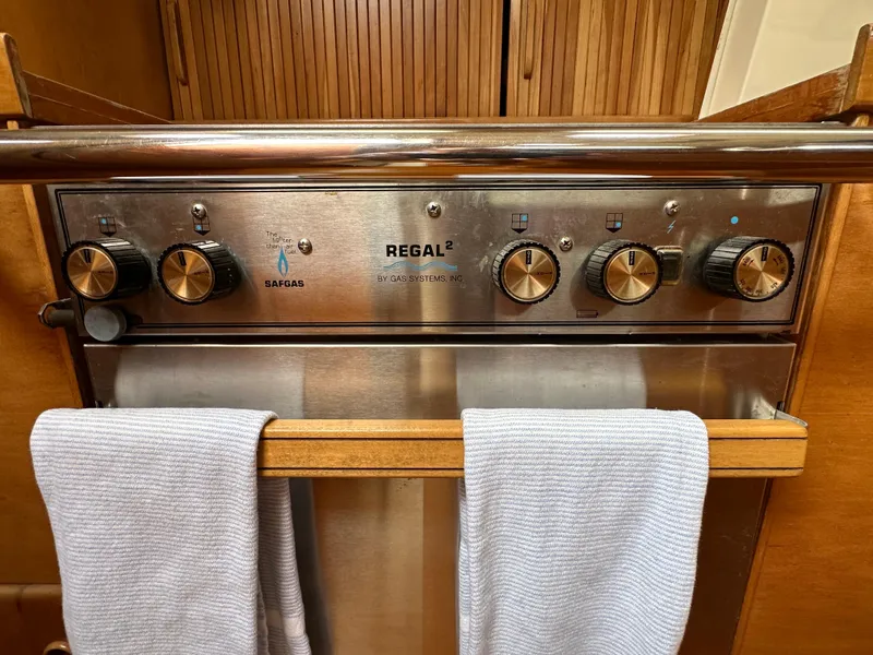 Slide: The Image of Control panel of a 1994 Sabre SABRE 425 gas stove with towels hanging below. - 18