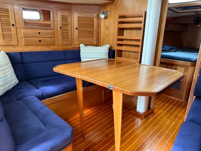 Slide: The Image of Luxurious 1994 Sabre 425 yacht interior with wooden table and blue seating. - 20