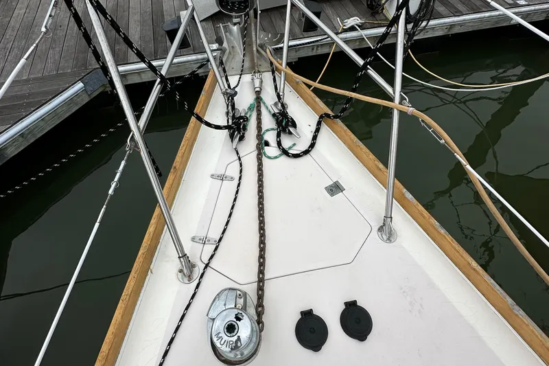Slide: The Image of Bow of 1994 Sabre SABRE 425 sailboat with anchor chain and deck fittings. - 25