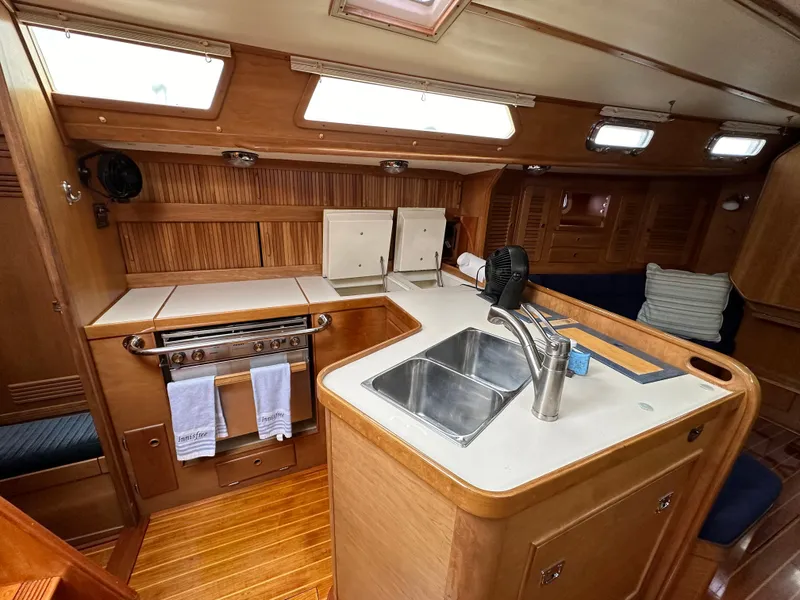 Slide: The Image of Interior of 1994 Sabre SABRE 425 yacht with wooden cabinetry and modern kitchen amenities. - 4
