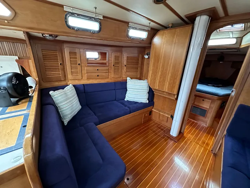 Slide: The Image of Cozy interior of 1994 Sabre SABRE 425 yacht with blue seating and wooden finishes. - 5
