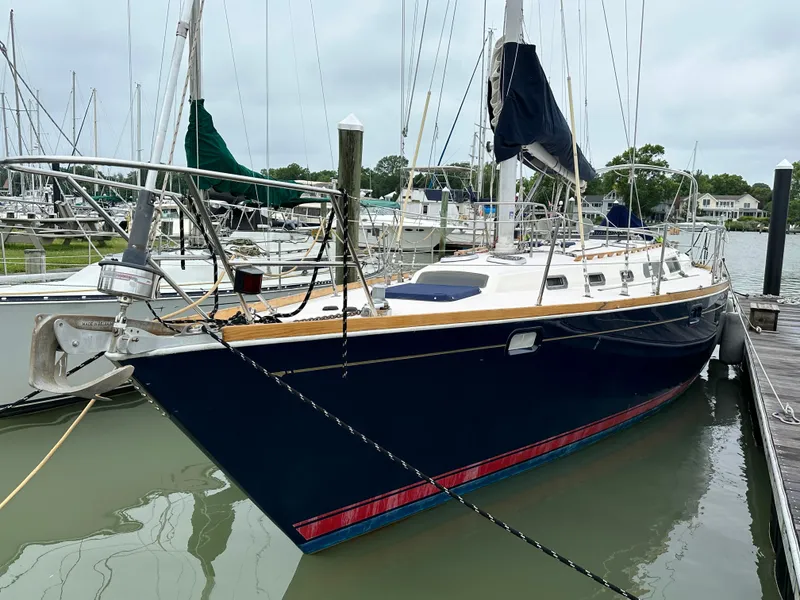 Slide: The Image of 1994 Sabre 425 sailboat docked in marina, featuring sleek design and blue hull. - 9