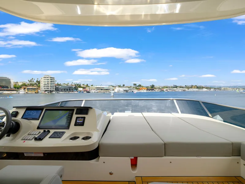 Slide: The Image of 2024 Absolute 60 Fly Co Ownership yacht helm with scenic waterfront view. - 17