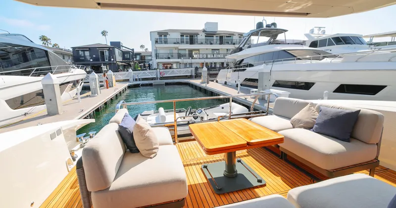 Slide: The Image of Luxurious 2024 Absolute 60 Fly Co Ownership yacht with elegant outdoor seating at a marina. - 20