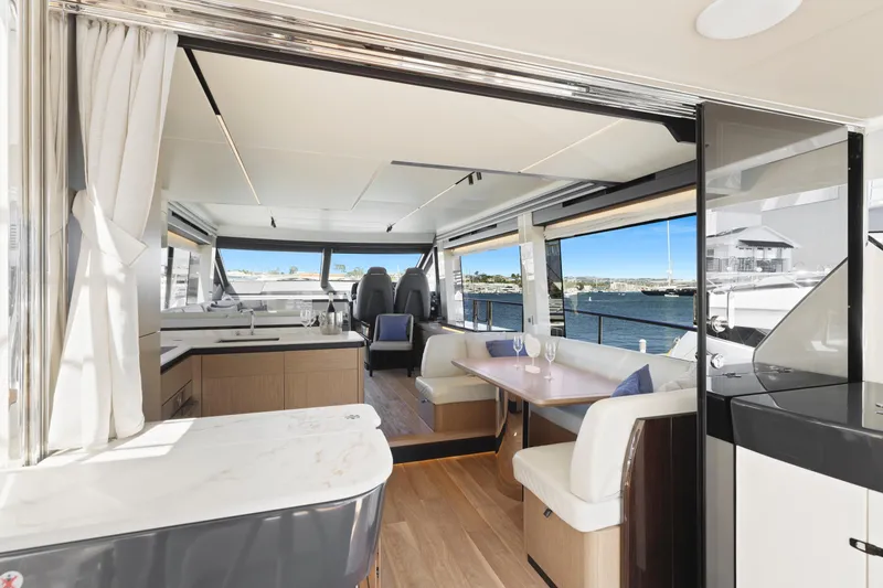 Slide: The Image of Luxurious interior of 2024 Absolute 60 Fly Co Ownership yacht with modern dining area and scenic views. - 23