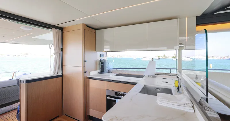 Slide: The Image of Luxurious kitchen interior of 2024 Absolute 60 Fly Co Ownership yacht with ocean view. - 24