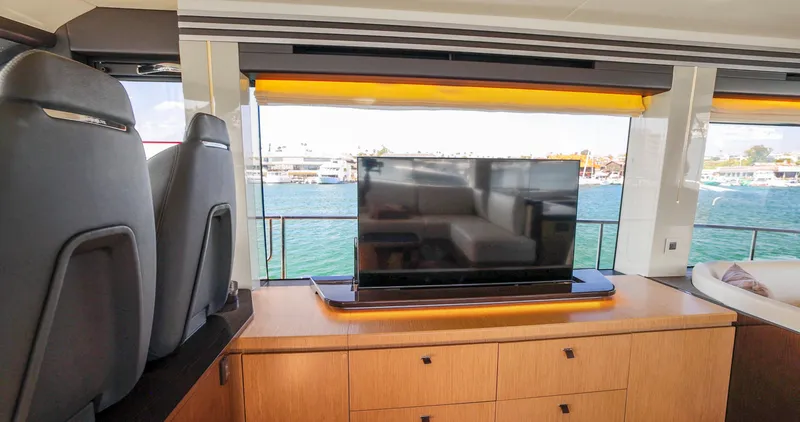 Slide: The Image of Interior of 2024 Absolute 60 Fly Co Ownership yacht with TV and ocean view. - 28