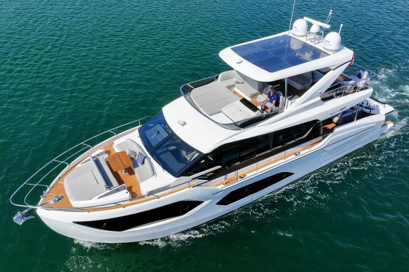 Slide: The Image of 2024 Absolute 60 Fly Co Ownership yacht cruising on clear blue water. - 4