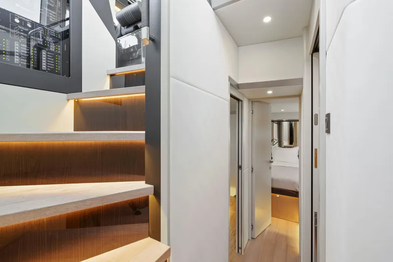 Slide: The Image of Interior of 2024 Absolute 60 Fly Co Ownership yacht, featuring modern staircase and hallway. - 42