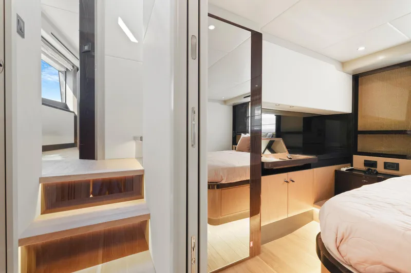 Slide: The Image of Luxurious interior of 2024 Absolute 60 Fly Co Ownership yacht, featuring modern bedroom and staircase. - 45