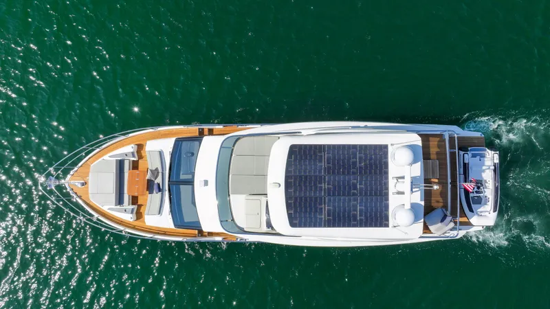 Slide: The Image of Aerial view of 2024 Absolute 60 Fly Co Ownership yacht cruising on open water. - 5