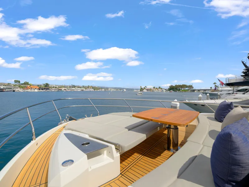 Slide: The Image of Luxurious 2024 Absolute 60 Fly yacht deck with scenic waterfront view. - 7