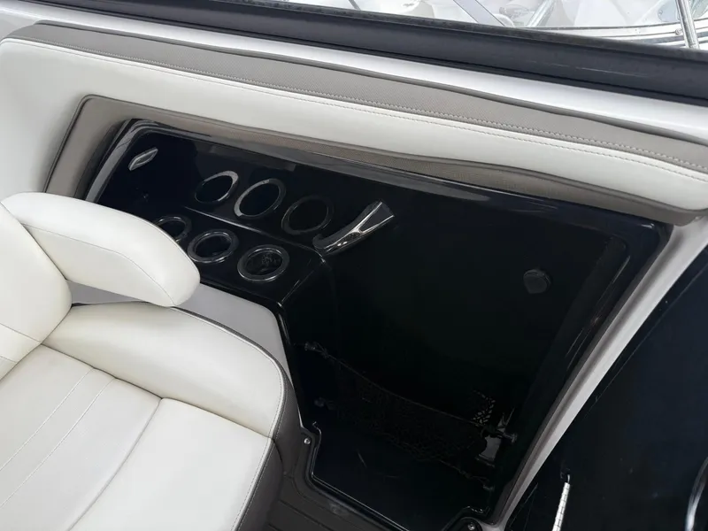 Slide: The Image of 2016 Yamaha Boats 242 Limited S E-Series interior with white seating and control panel. - 35