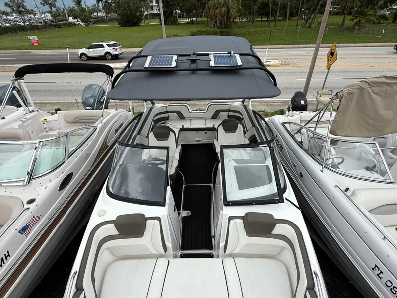 Slide: The Image of 2016 Yamaha Boats 242 Limited S E-Series with solar panels, docked among other boats. - 41