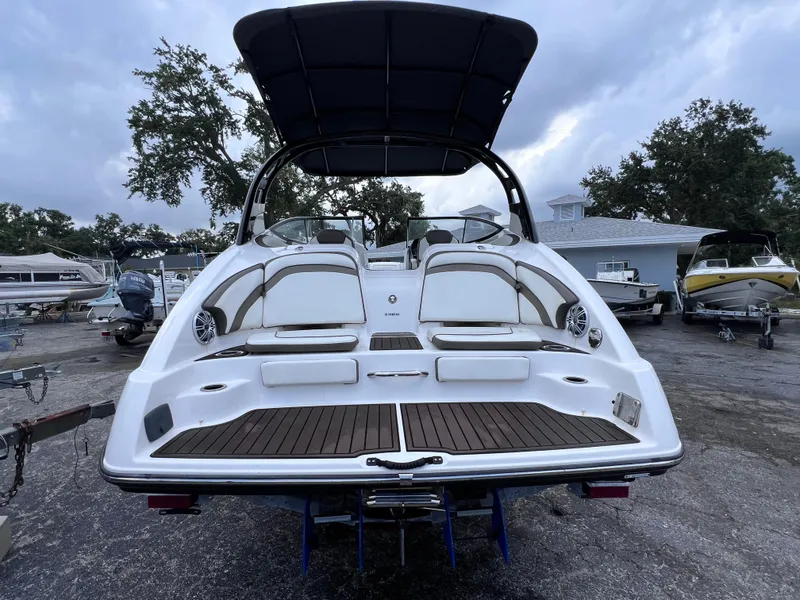 Slide: The Image of 2016 Yamaha Boats 242 Limited S E-Series, rear view, docked with canopy. - 5