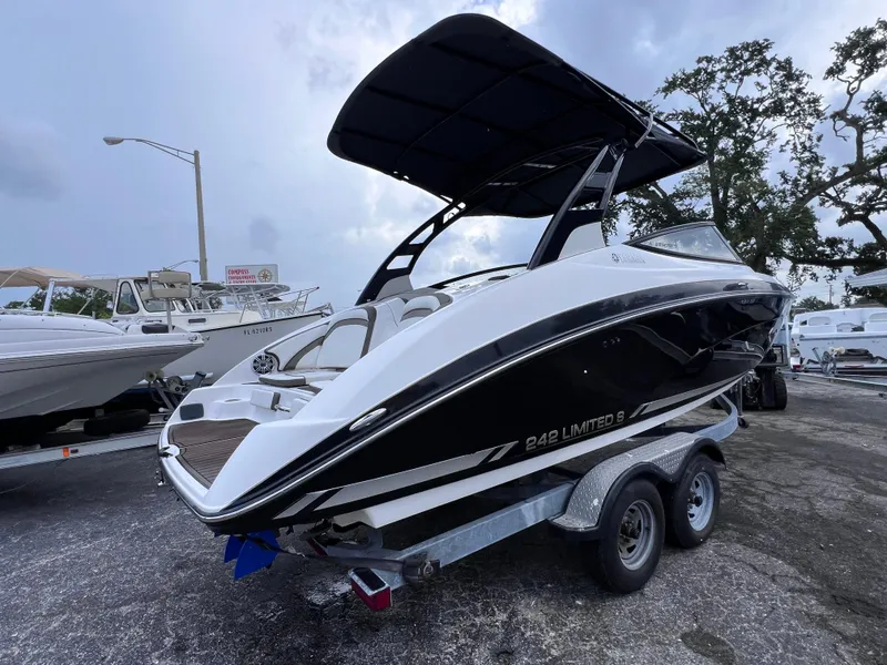 Slide: The Image of 2016 Yamaha Boats 242 Limited S E-Series on trailer, sleek design, black and white exterior. - 7