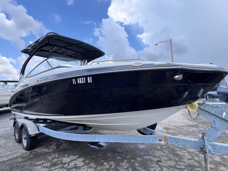 Slide: The Image of 2016 Yamaha Boats 242 Limited S E-Series on trailer, under cloudy sky. - 0
