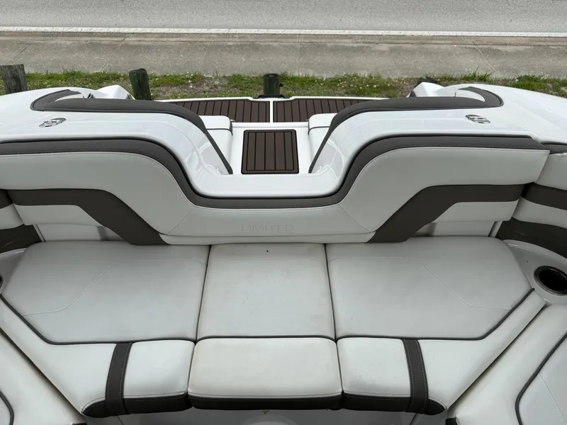 Slide: The Image of 2016 Yamaha Boats 242 Limited S E-Series interior seating, featuring sleek white and gray upholstery. - 32
