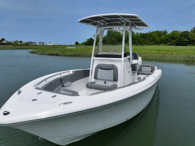 Slide: The Image of 2025 NauticStar 212 Legacy boat on calm water, featuring sleek design and modern amenities. - 10