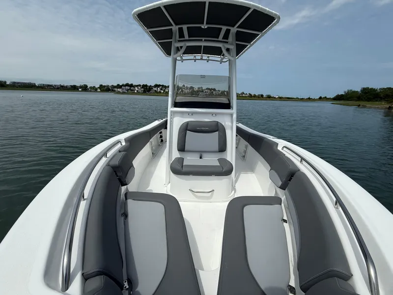 Slide: The Image of 2025 NauticStar 212 Legacy boat with sleek seating on calm water. - 12