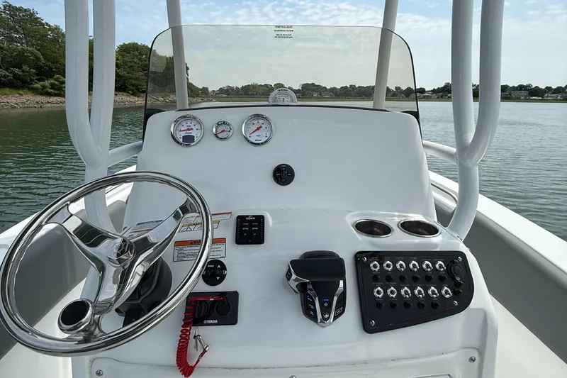 Slide: The Image of 2025 NauticStar 212 Legacy boat dashboard with steering wheel and control panel. - 14
