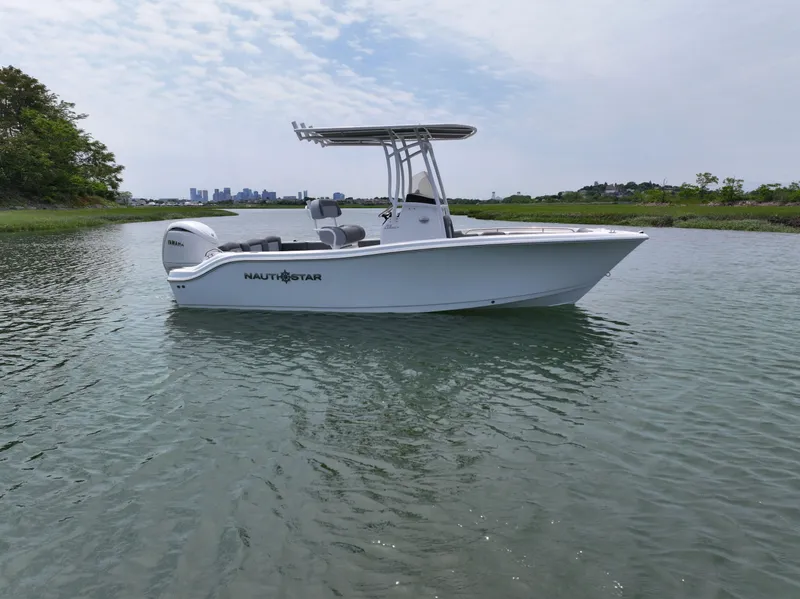 Slide: The Image of 2025 NauticStar 212 Legacy boat on calm water, clear sky background. - 4