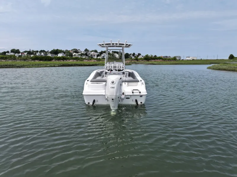 Slide: The Image of 2025 NauticStar 212 Legacy boat on calm water, rear view. - 5
