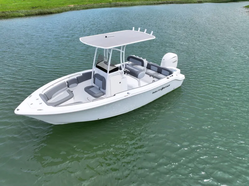 Slide: The Image of 2025 NauticStar 212 Legacy boat on calm water, featuring sleek design and spacious seating. - 8