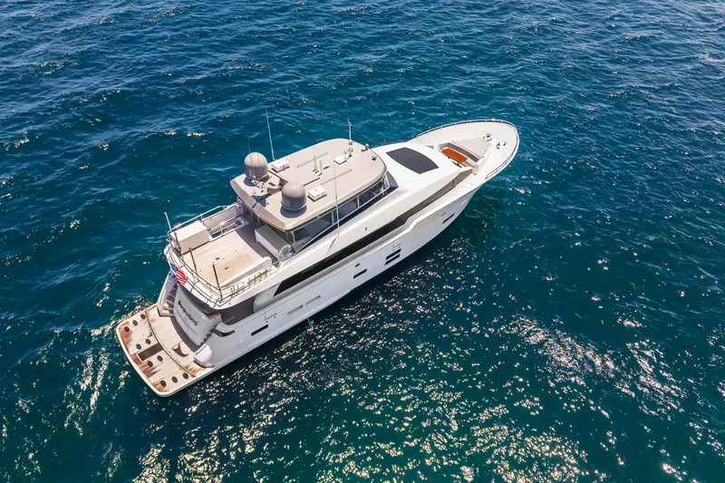 Slide: The Image of 2019 Hatteras M90 Panacera yacht cruising on open blue sea. - 2