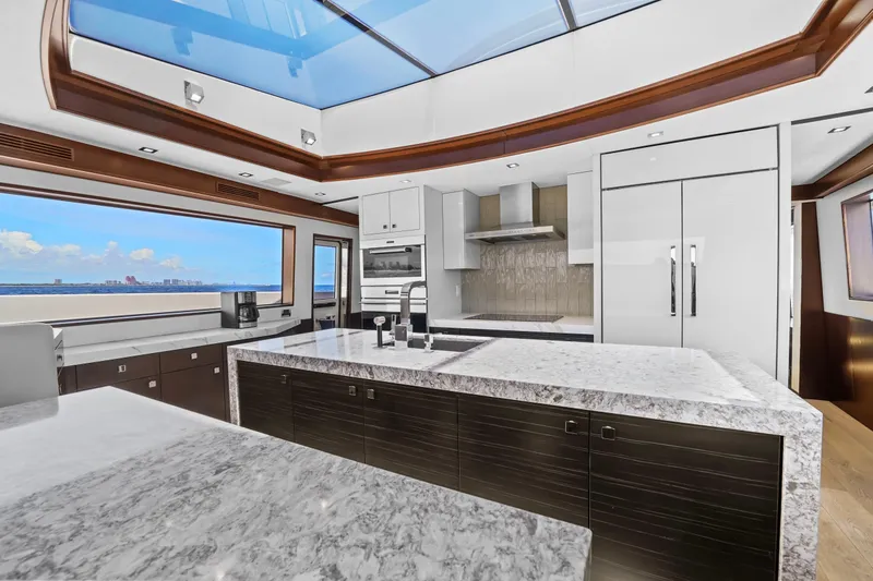 Slide: The Image of Luxurious kitchen interior of 2019 Hatteras M90 Panacera yacht with marble countertops and ocean view. - 23