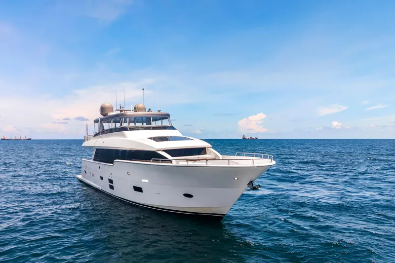 Slide: The Image of Luxury 2019 Hatteras M90 Panacera yacht cruising on open sea under clear blue sky. - 3