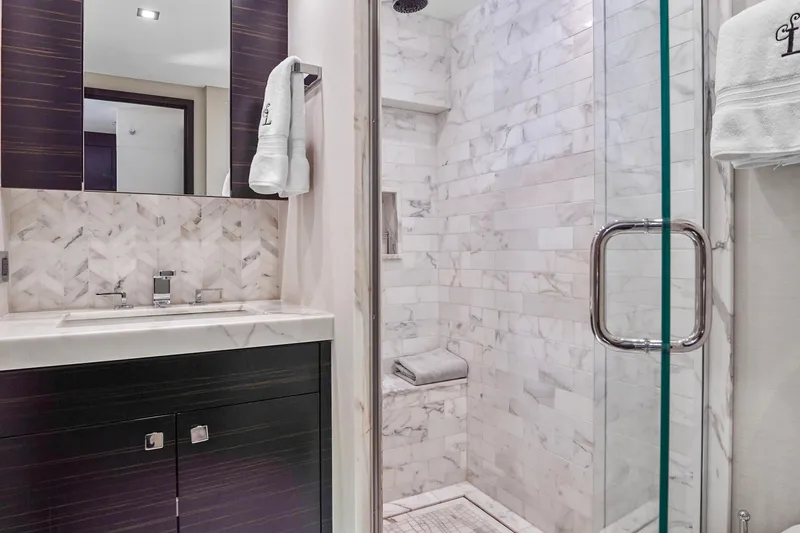 Slide: The Image of Luxurious bathroom in 2019 Hatteras M90 Panacera yacht with marble shower and modern vanity. - 31