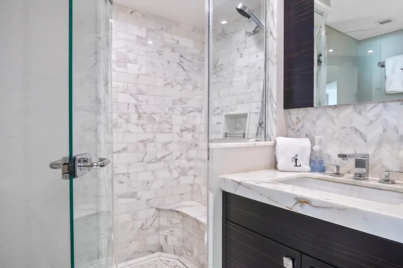 Slide: The Image of Luxurious marble bathroom in 2019 Hatteras M90 Panacera yacht, featuring modern fixtures and glass shower. - 35