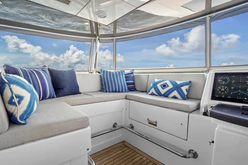 Slide: The Image of Luxurious interior of 2019 Hatteras M90 Panacera yacht with plush seating and nautical decor. - 7