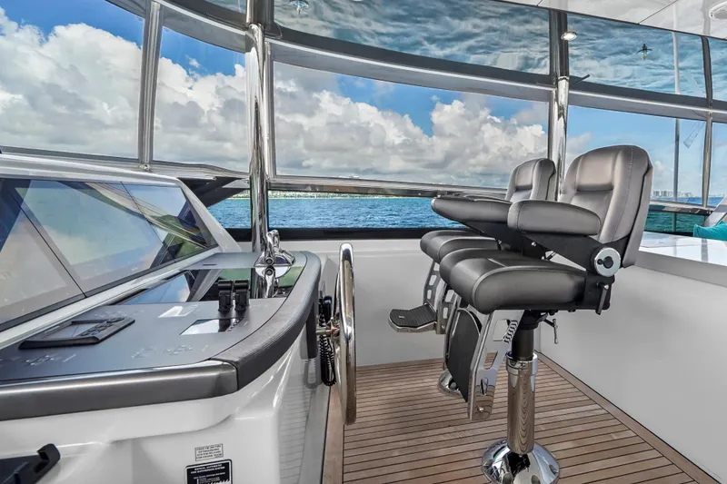 Slide: The Image of Helm station of 2019 Hatteras M90 Panacera yacht with leather seats and ocean view. - 8