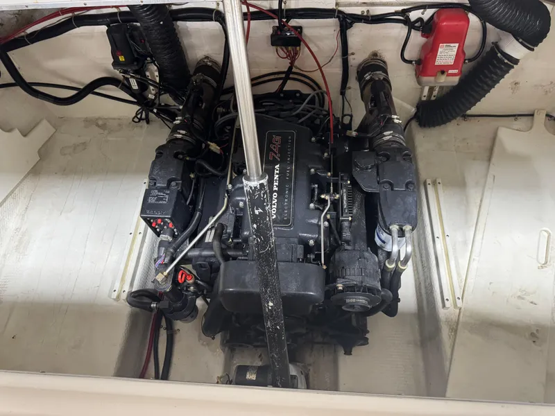 Slide: The Image of Engine compartment of a 1997 Thompson Torrent 2900 boat, featuring a well-maintained motor. - 10