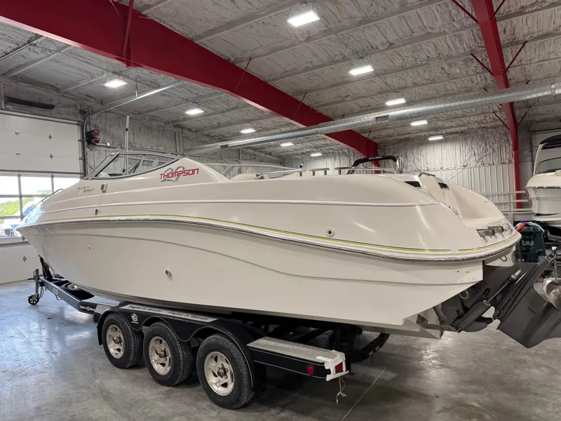 Slide: The Image of 1997 Thompson Torrent 2900 boat on trailer in indoor storage facility. - 4