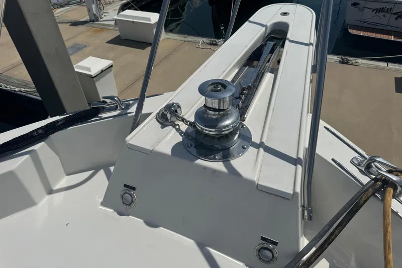 Slide: The Image of Bow of 1995 Hatteras 74 Cockpit Motor Yacht with anchor winch and railing. - 12